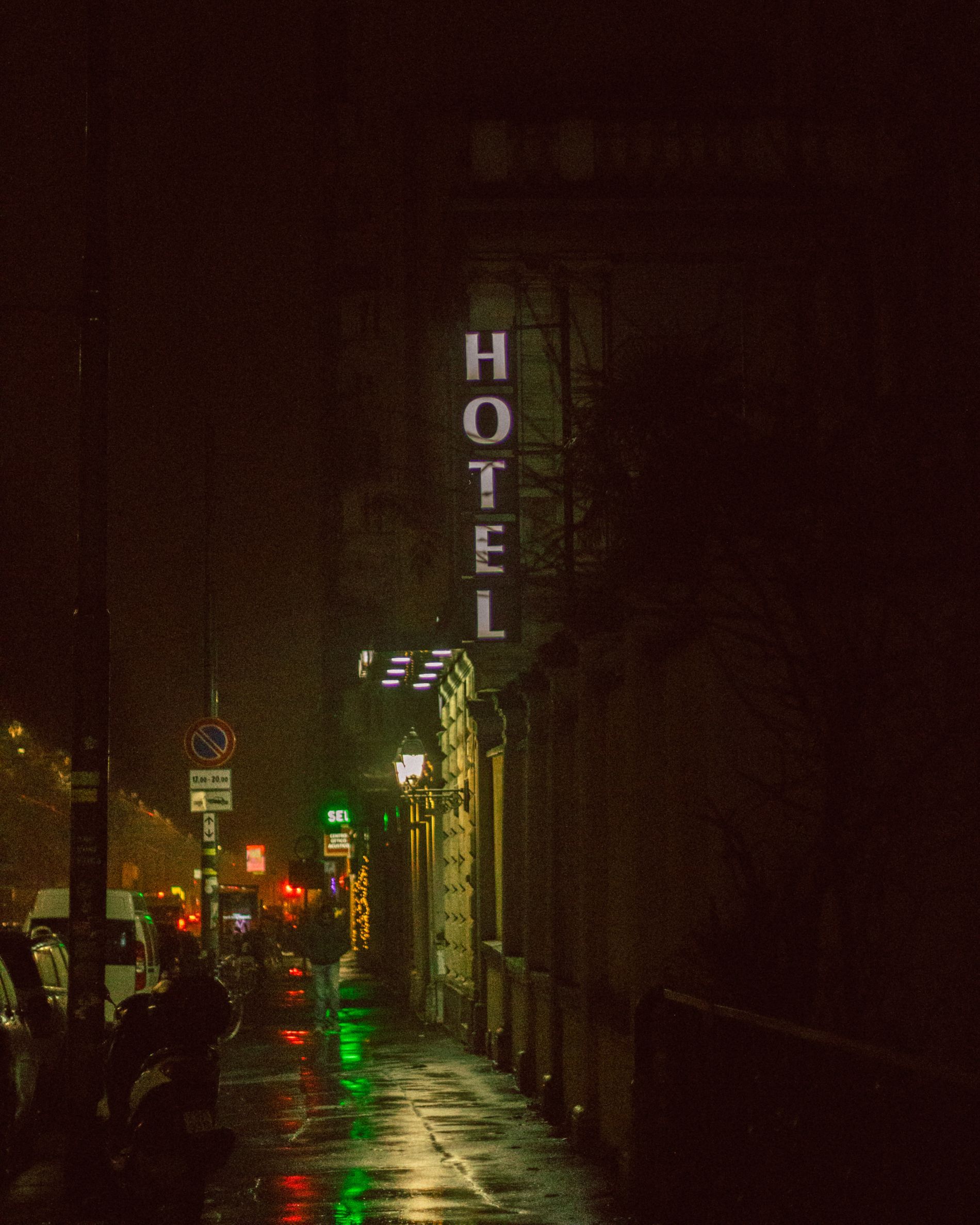 A neon hotel sign glowing in the dark