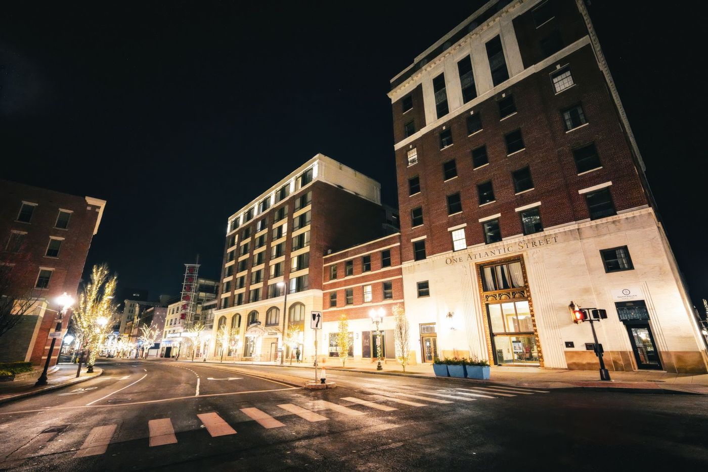 Warm streetlights over empty downtown pavement