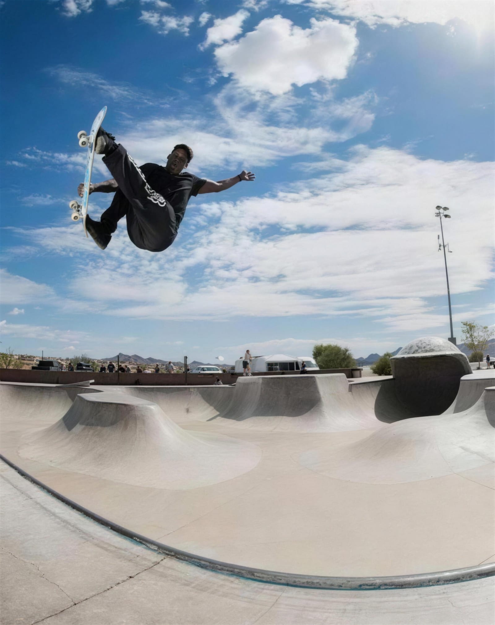 Skateboarder mid-kickflip at a Springfield skatepark