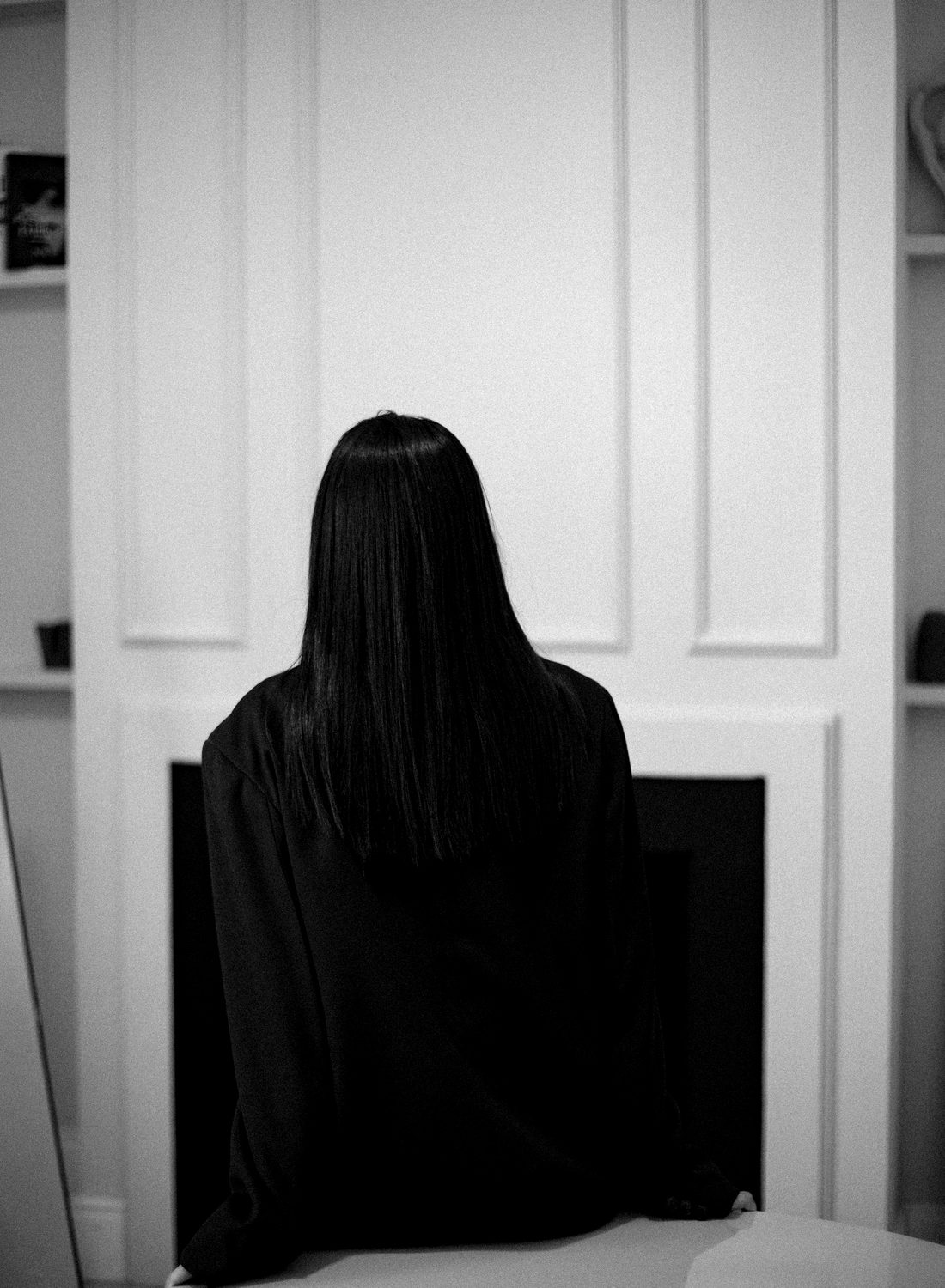 Portrait of a woman from behind, hair falling in soft light