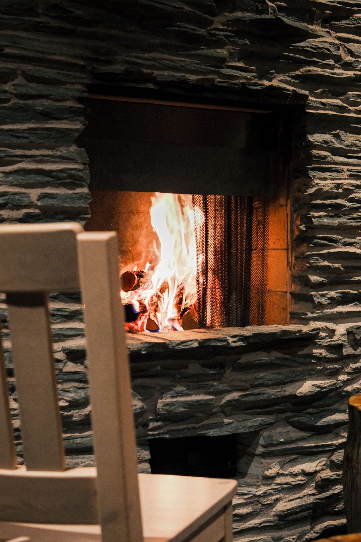 Stone fireplace with burning firewood