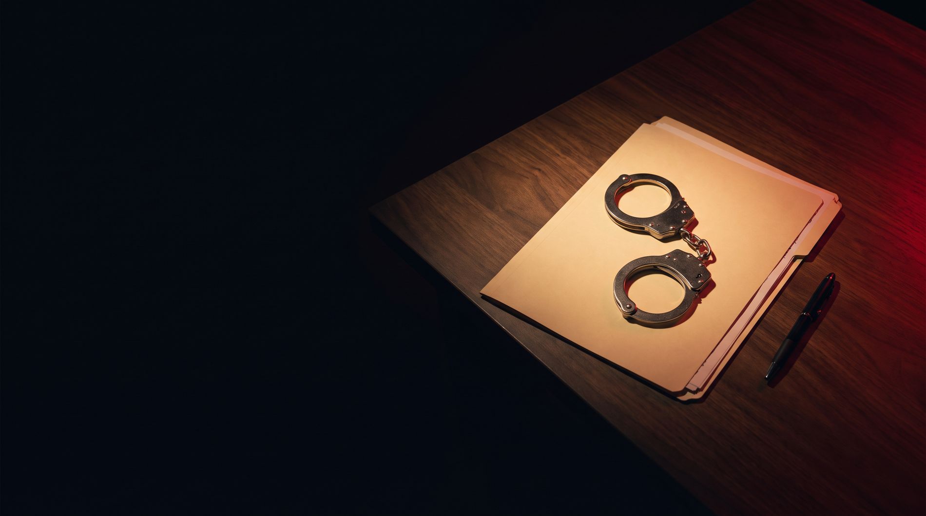 Handcuffs resting on a case file