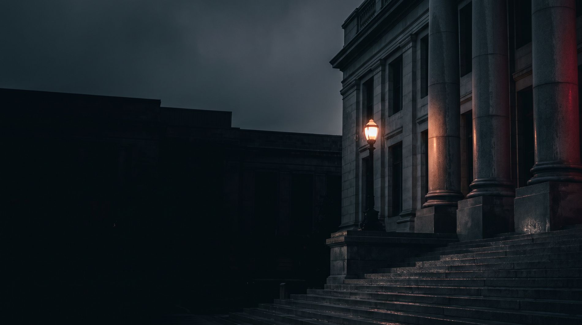 Courthouse steps under a lamp at night