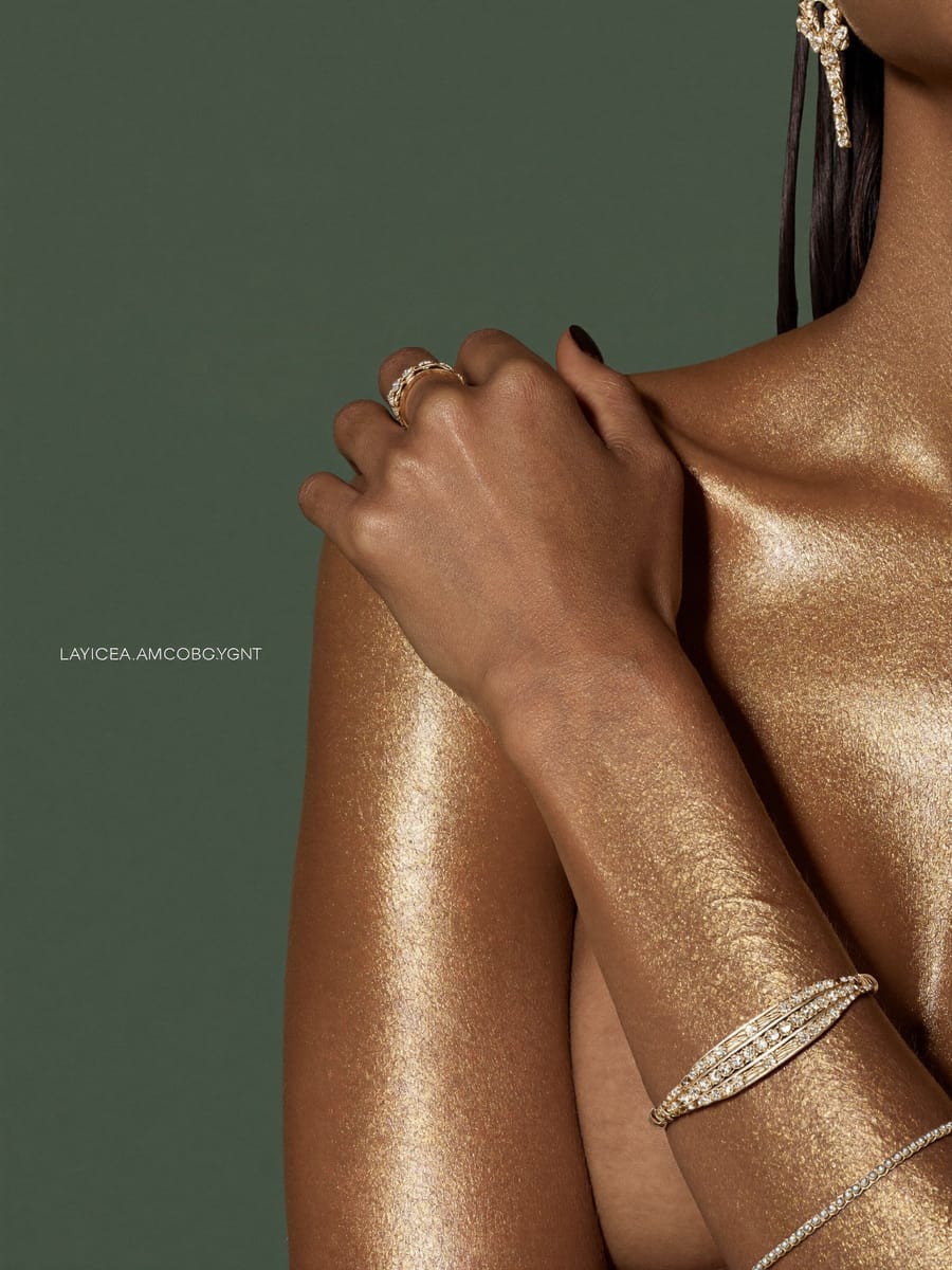 Golden spray tan glow against sage green