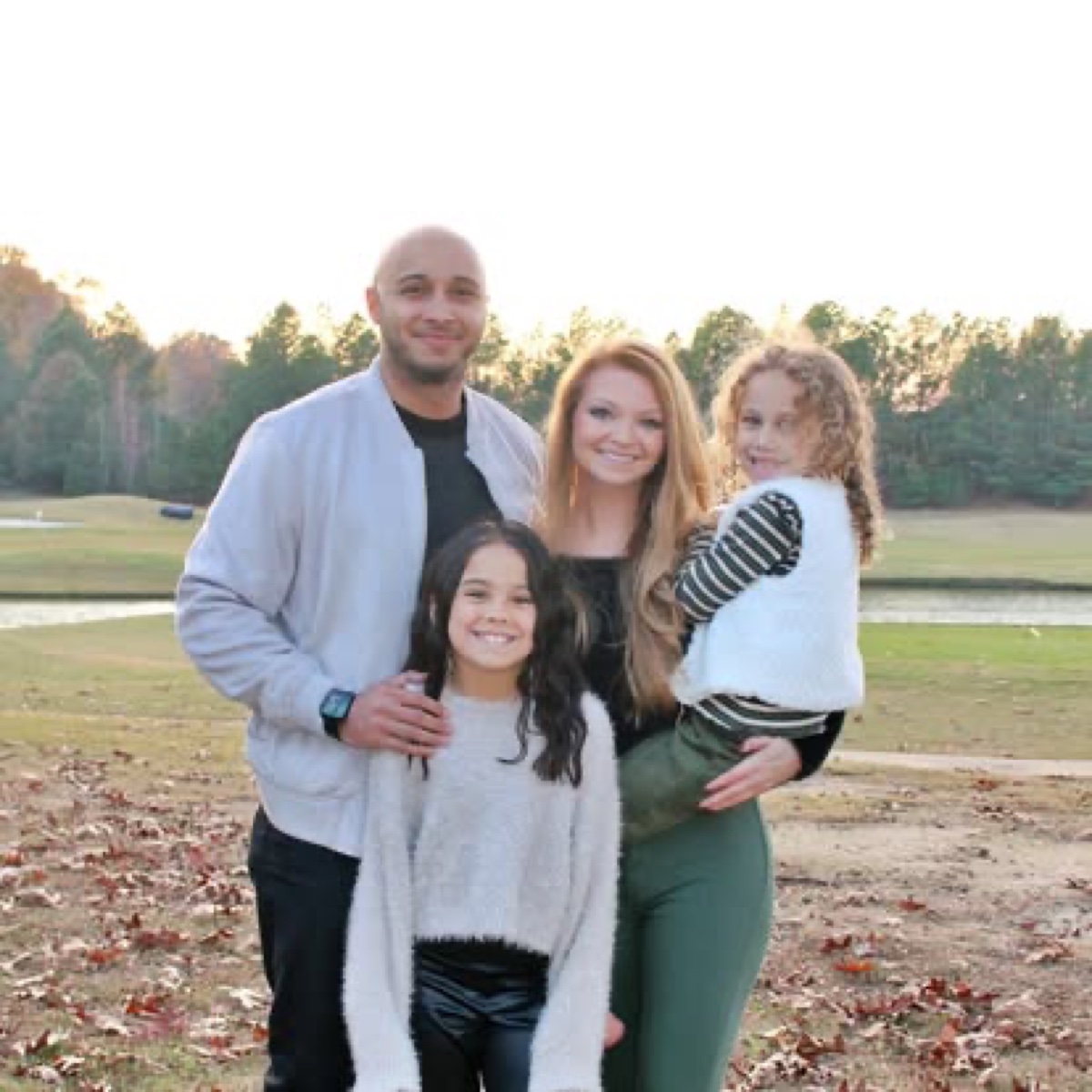 Dante Robertson with his wife and two daughters at the lake